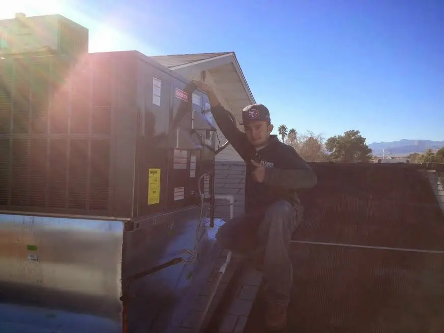 HVAC technician performing HVAC Inspection on a rooftop unit in Hoquiam